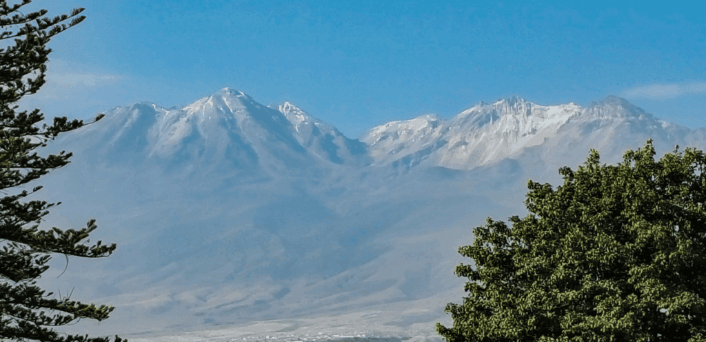 The volcano and mountains are seen in the distance