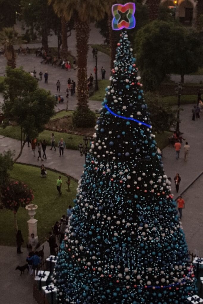 View of Plaza de Armas at night from a rooftop terrace with Christmas Tree in foreground