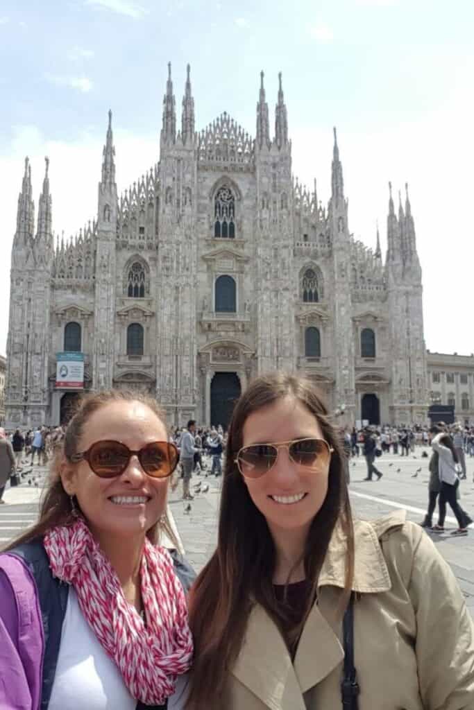 mom and daughter standing in front of Il Duomo in Milan