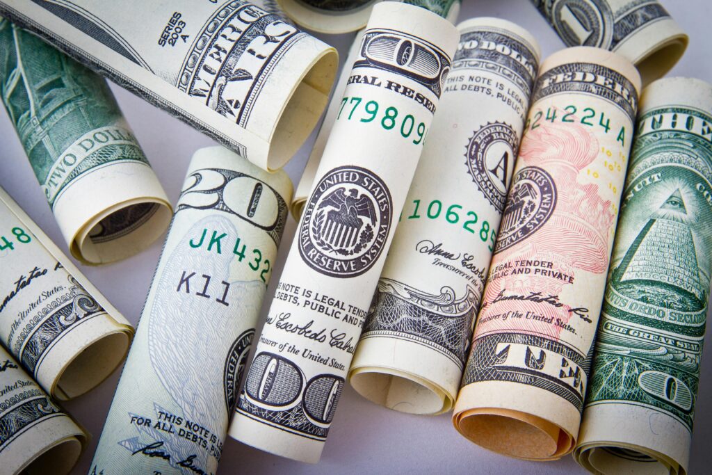 rolls of bills, budget tips for traveling