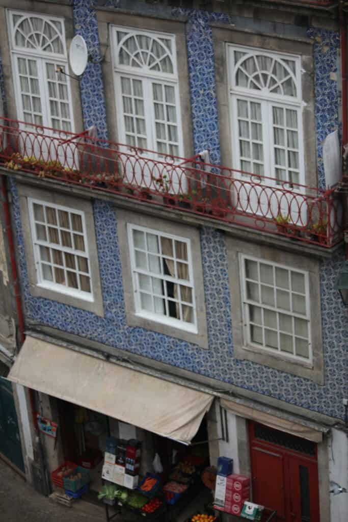 Building with wrought iron balconies and azulejo tiles.